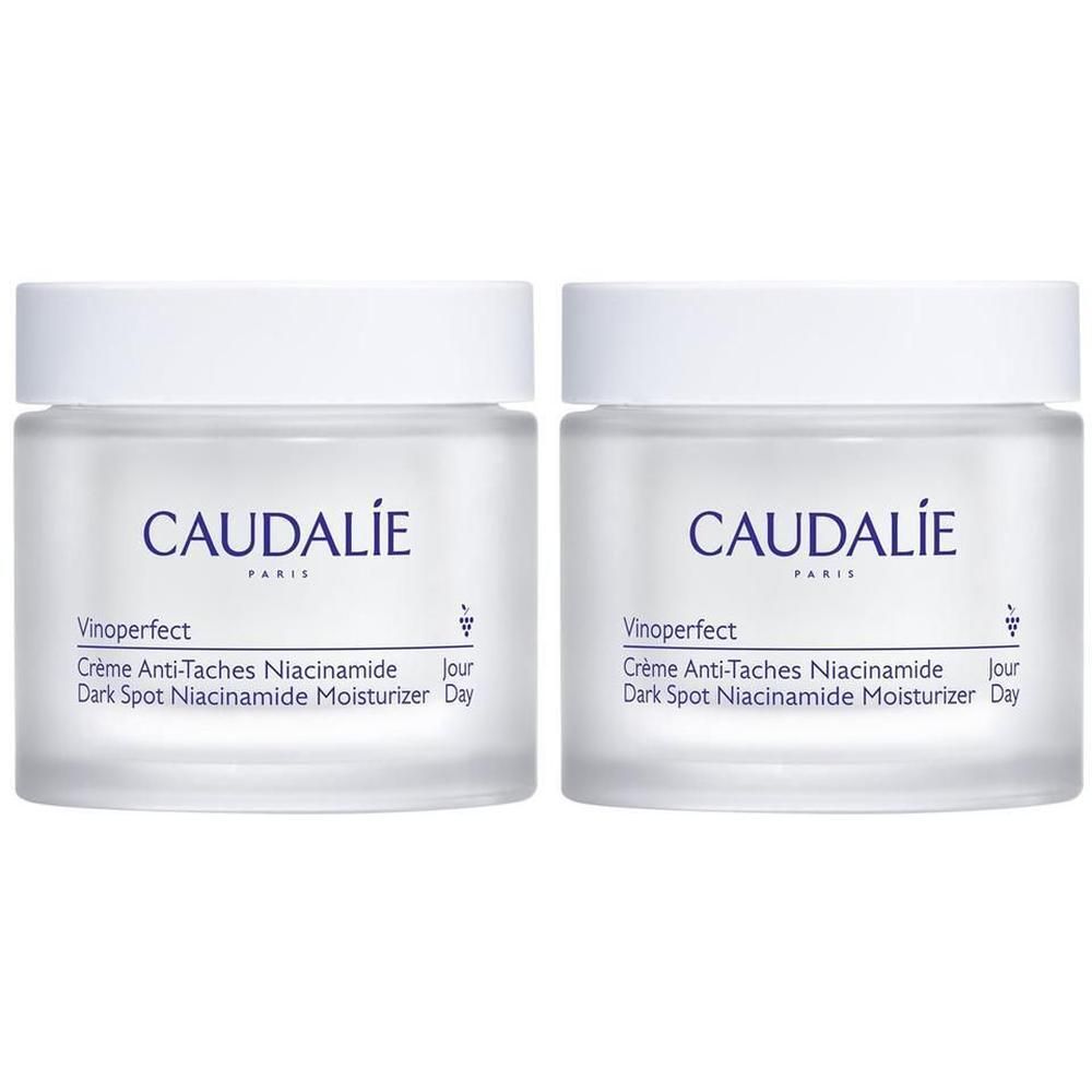 Deux pots de crème avec couvercles blancs. Inscription: CAUDALIE, Vinoperfect, Crème Anti-Taches Niacinamide, Dark Spot Niacinamide Moisturizer Day.