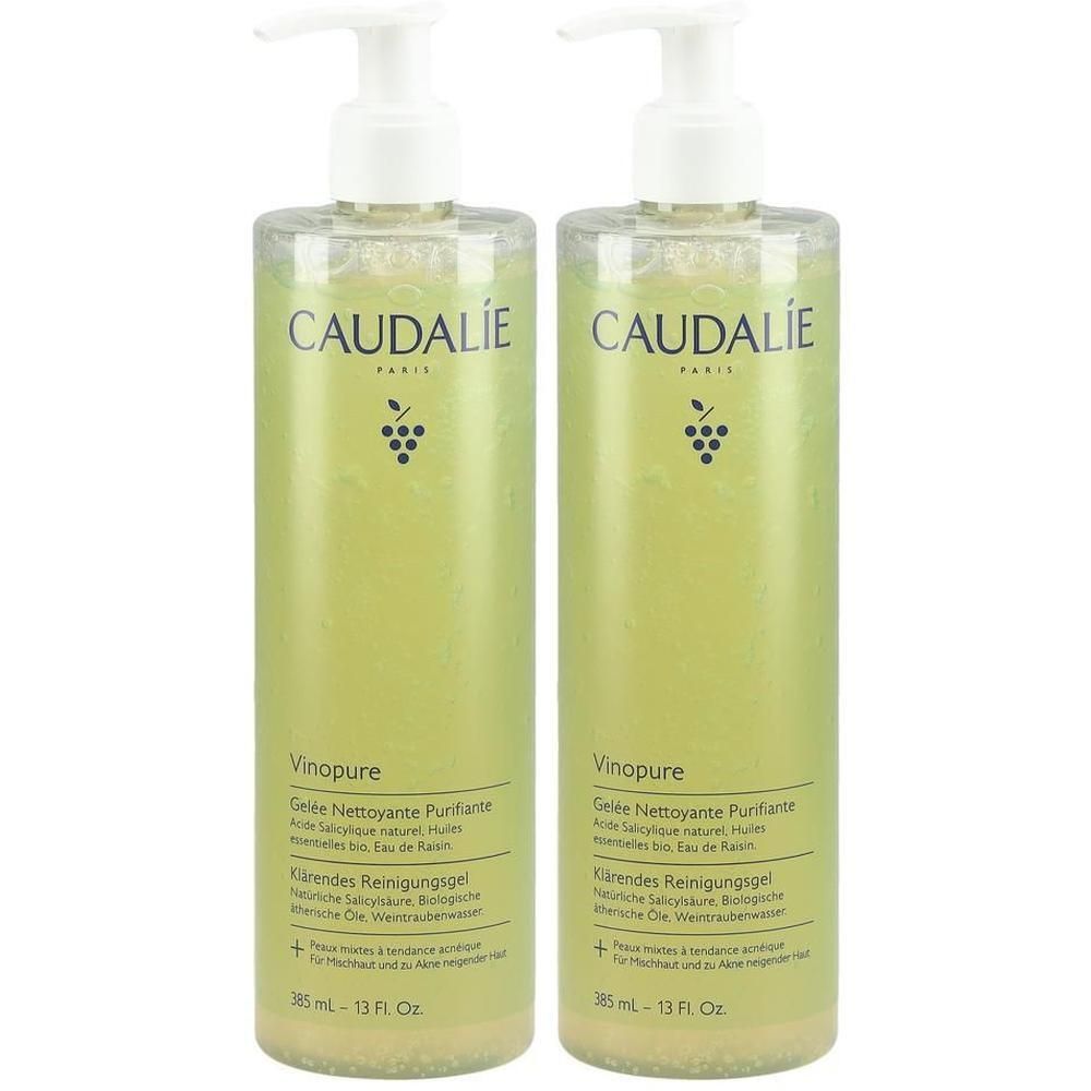 Deux flacons de gel nettoyant CAUDALIE Vinopure. Liquide clair et vert dans des bouteilles cylindriques avec des pompes blanches. Étiquetage du produit visible.