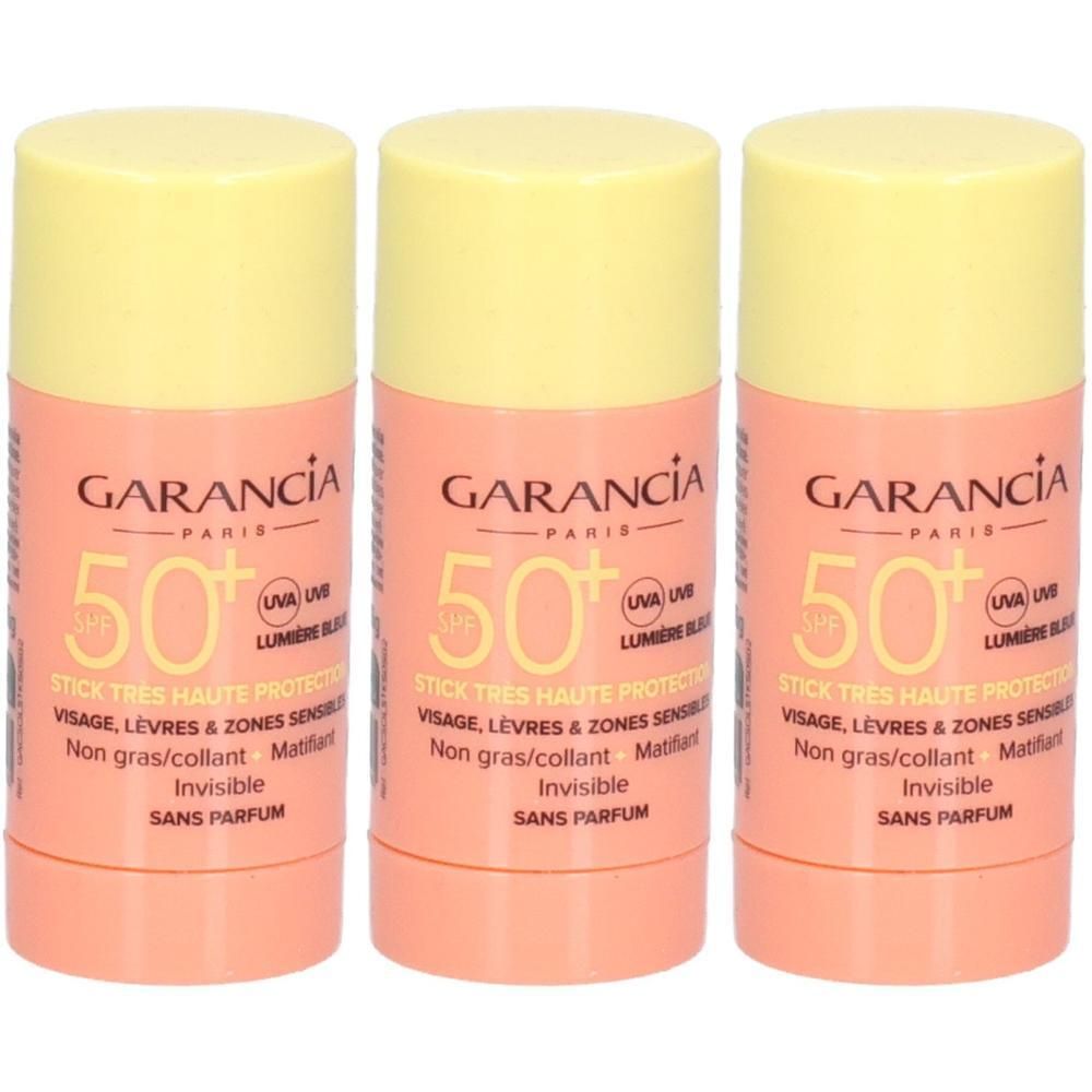 Drei zylindrische Sonnenstifte mit gelben Kappen. Aufschrift: GARANCIA, 50+ SPF, für Gesicht, Lippen und empfindliche Zonen. Ohne Parfüm.