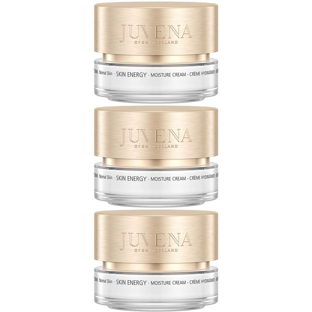 Trois pots de crème hydratante JUVENA SKIN ENERGY. Couvercles dorés, pots transparents. Inscription : SKIN ENERGY, Moisture Cream.