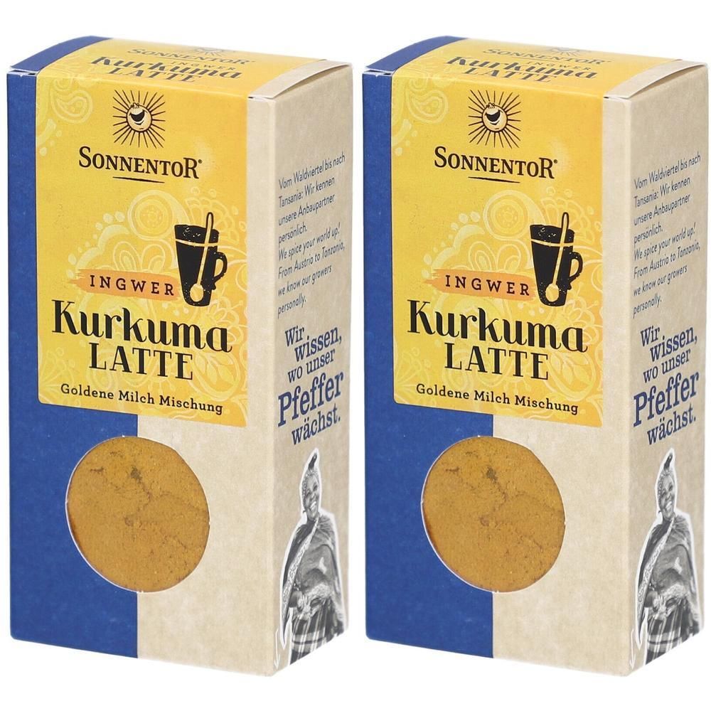 Zwei Kartonverpackungen mit SONNENTOR Kurkuma Latte. Gelbe Schrift auf blauem Grund. Sichtbares Pulver in einem runden Fenster.