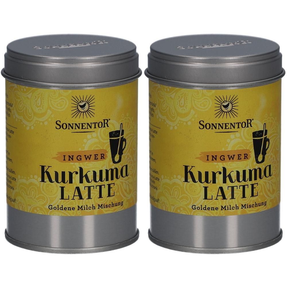 Zwei zylindrische Dosen mit Deckel. Auf gelbem Hintergrund steht "SONNENTOR Kurkuma Latte Ingwer". Logo mit Tasse. Goldene Milch Mischung.