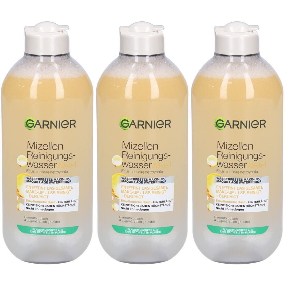 Trois bouteilles de démaquillant micellaire Garnier avec liquide jaunâtre et bouchon blanc. Étiquette avec logo Garnier et informations produit.