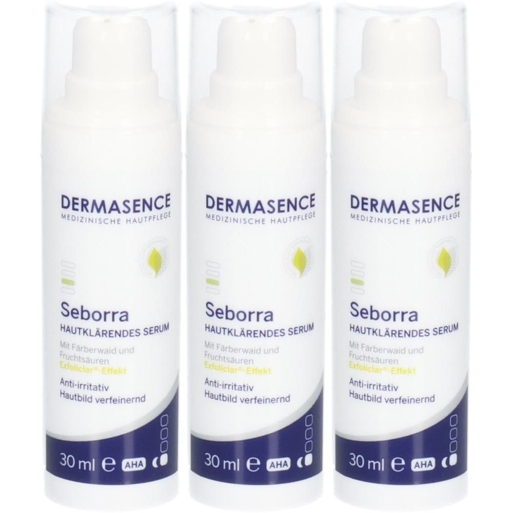 Drei Flaschen DERMASENCE Seborra Serum. Weiße Flaschen mit blauem und grünem Etikett. Text: Seborra, hautklärendes Serum, 30 ml.