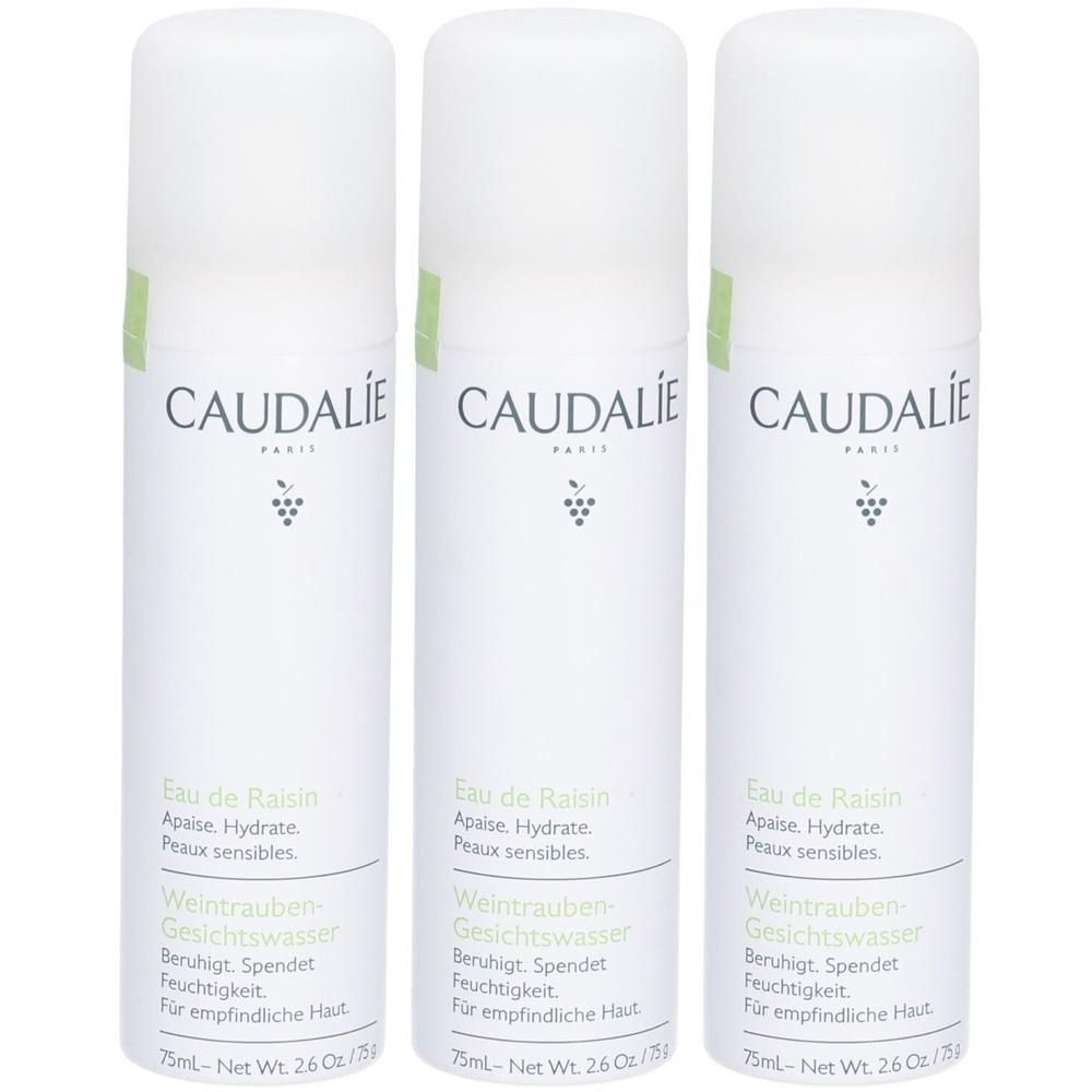 Drei weiße Sprühflaschen mit grünen Akzenten. Aufschrift: CAUDALIE, Eau de Raisin, Weintrauben-Gesichtswasser. Für empfindliche Haut.
