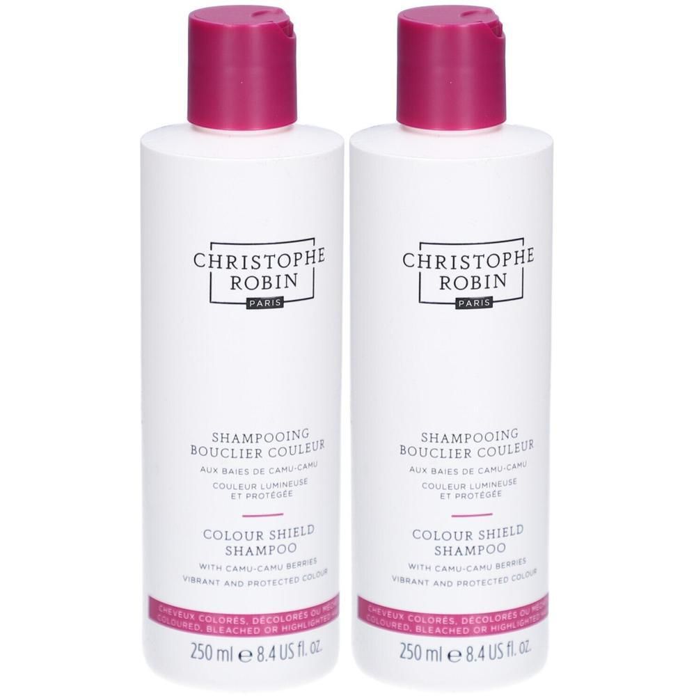 Zwei weiße Flaschen mit pinkfarbenen Deckeln. Aufschrift: CHRISTOPHE ROBIN, SHAMPOOING BOUCLIER COULEUR, COLOUR SHIELD SHAMPOO.