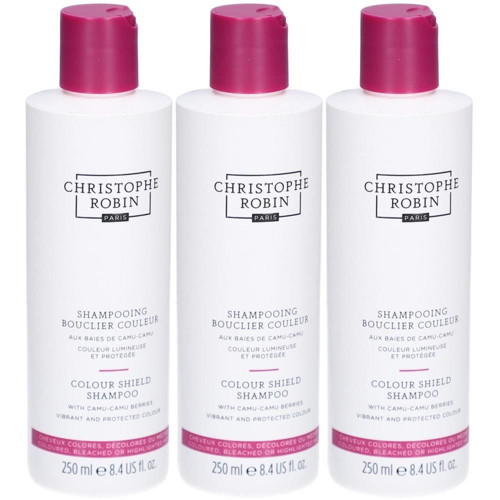 Drei weiße Flaschen mit pinkfarbenen Deckeln. Auf jeder Flasche steht „CHRISTOPHE ROBIN PARIS“ und „COLOUR SHIELD SHAMPOO“.