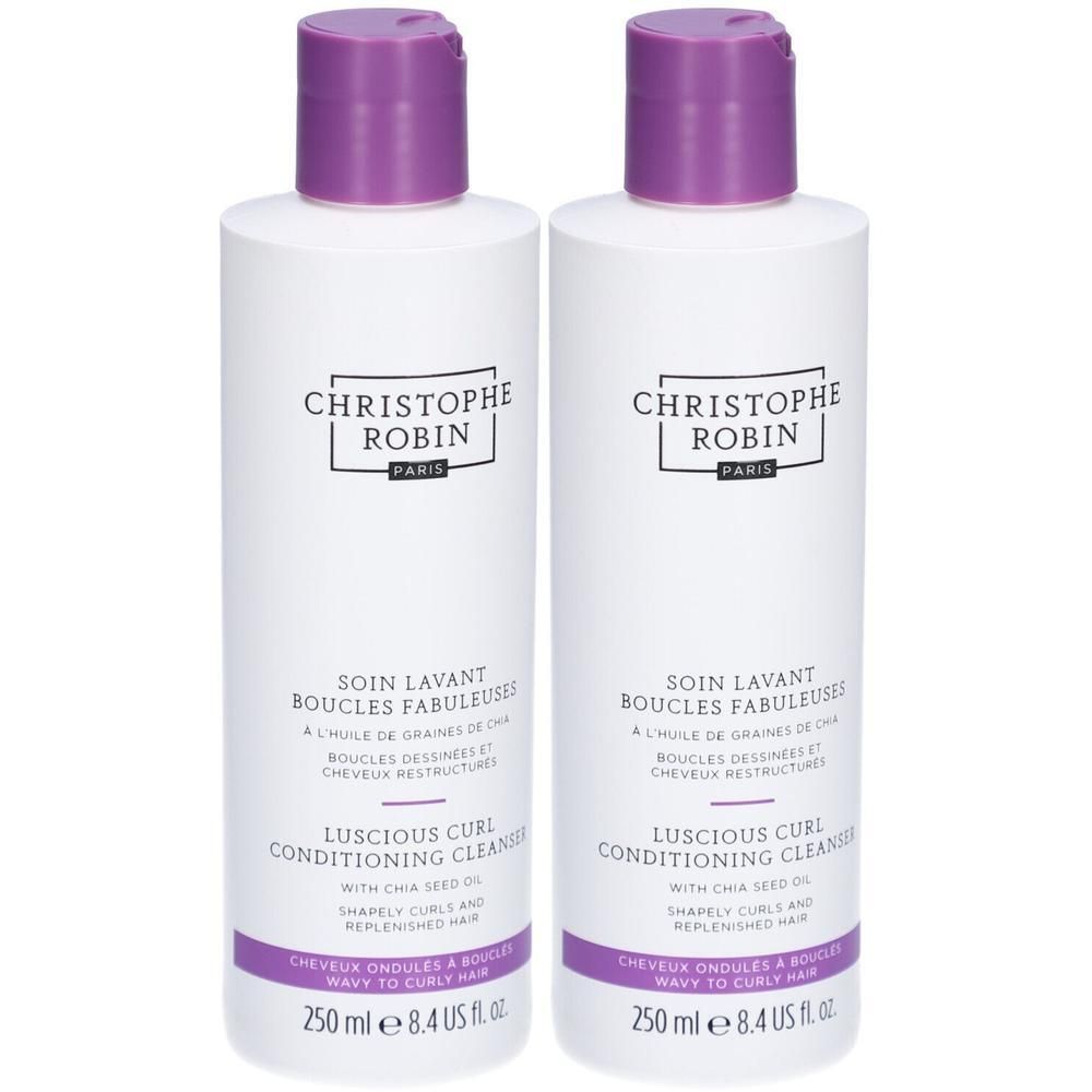 Zwei weiße Flaschen mit lila Deckeln. Aufschrift: CHRISTOPHE ROBIN, SOIN LAVANT BOUCLES FABULEUSES, LUSCIOUS CURL CONDITIONING CLEANSER.