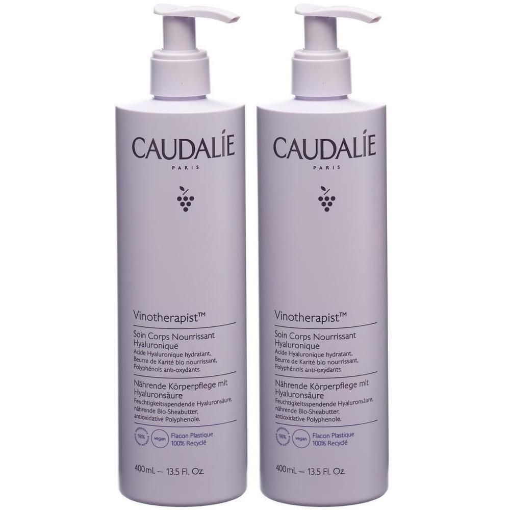 Zwei Flaschen CAUDALIE Vinotheraptist. Hellviolette Flaschen mit Pumpaufsatz. Aufschrift: CAUDALIE PARIS, Vinotheraptist, Soin Corps Nourrissant.
