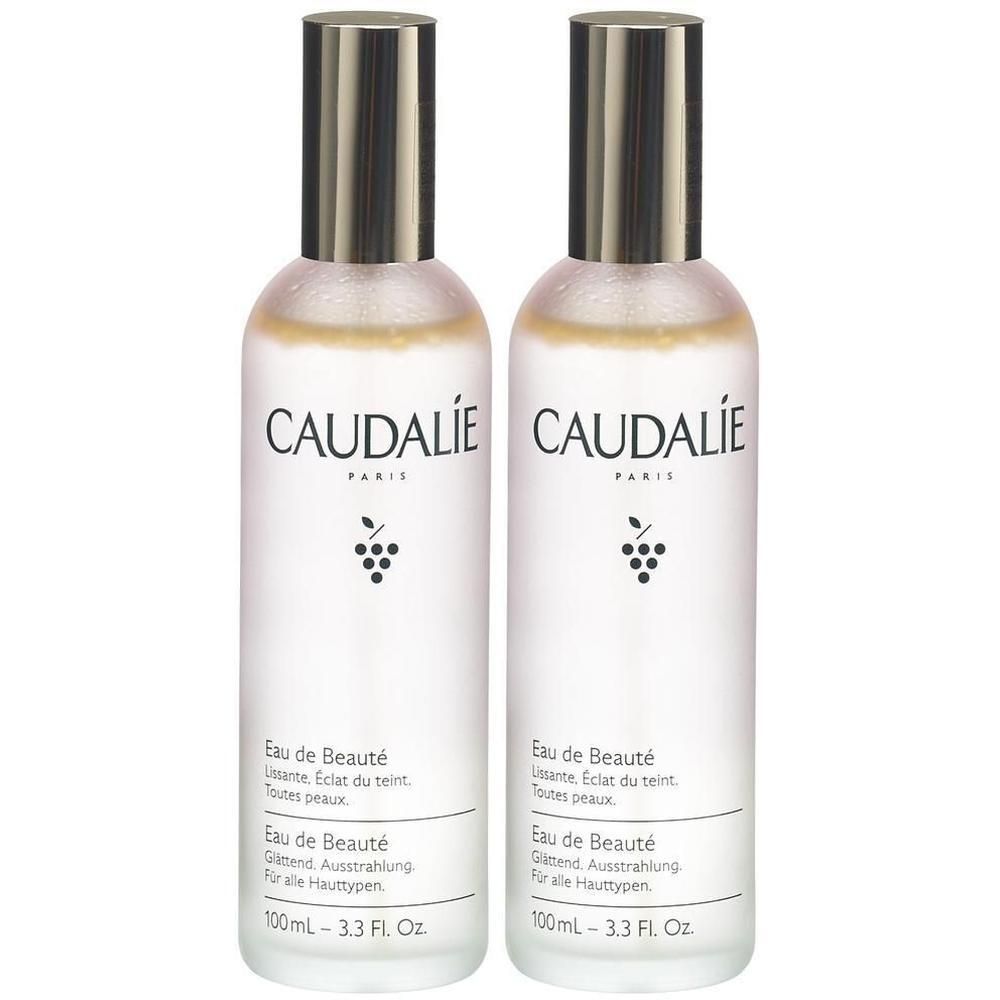 Zwei Flaschen mit silbernen Deckeln. Aufschrift: CAUDALIE PARIS, Eau de Beauté. Untertitel in Deutsch und Französisch. 100ml.