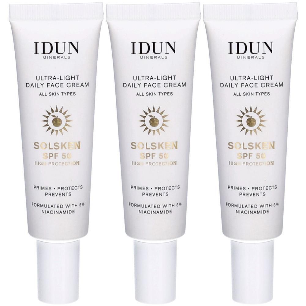Drei Tuben IDUN Minerals Ultra-Light Daily Face Cream. Weiße Tuben mit schwarzer Schrift und goldenem Logo. SPF 50.