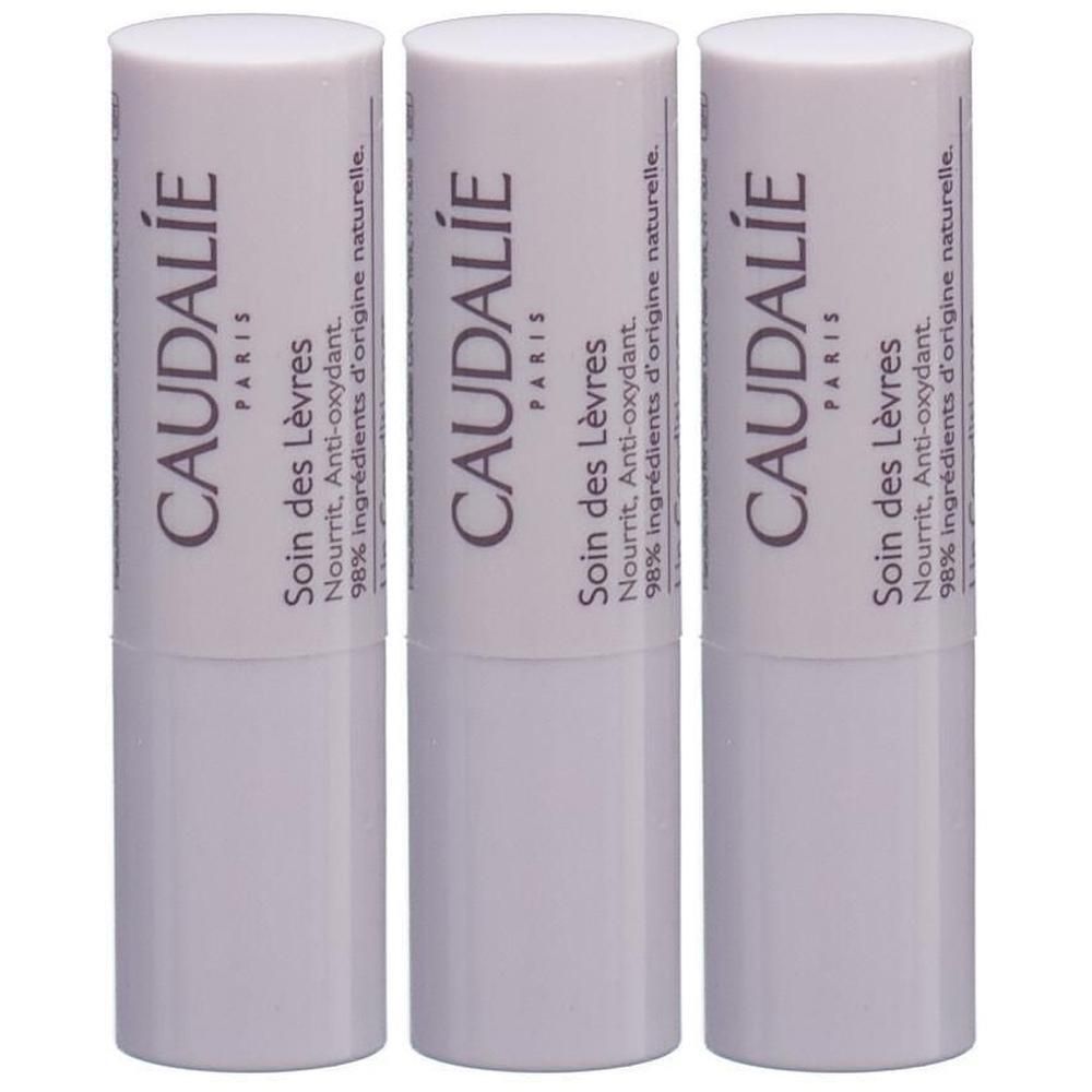 Drei weiße Lippenpflegestifte mit Deckel. Aufschrift: CAUDALIE PARIS, Soin des Lèvres, Nourrit, Anti-oxydant, 98% ingrédients d'origine naturelle.