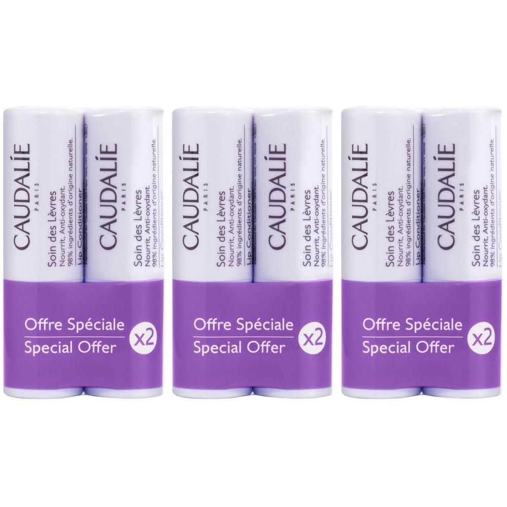 Drei Packungen mit je zwei Caudalie Lippenpflege-Stiften, lila "Offre Spéciale" Aufdruck.
