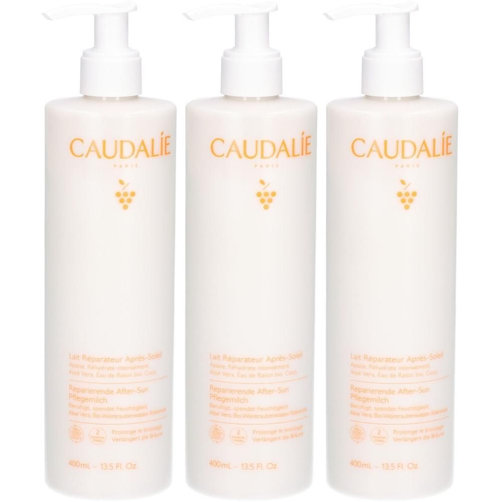 Drei weiße Pumpflaschen mit Caudalie After-Sun-Lotion, 400ml.