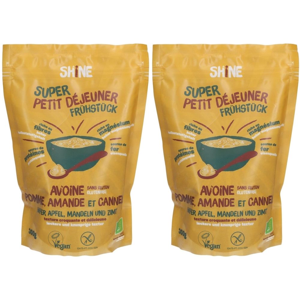 Zwei Beutel Shine BIO-Frühstücksflocken. Aufschrift: Super Petit Déjeuner Frühstück. Hafer, Apfel, Mandel & Zimt. Vegan.