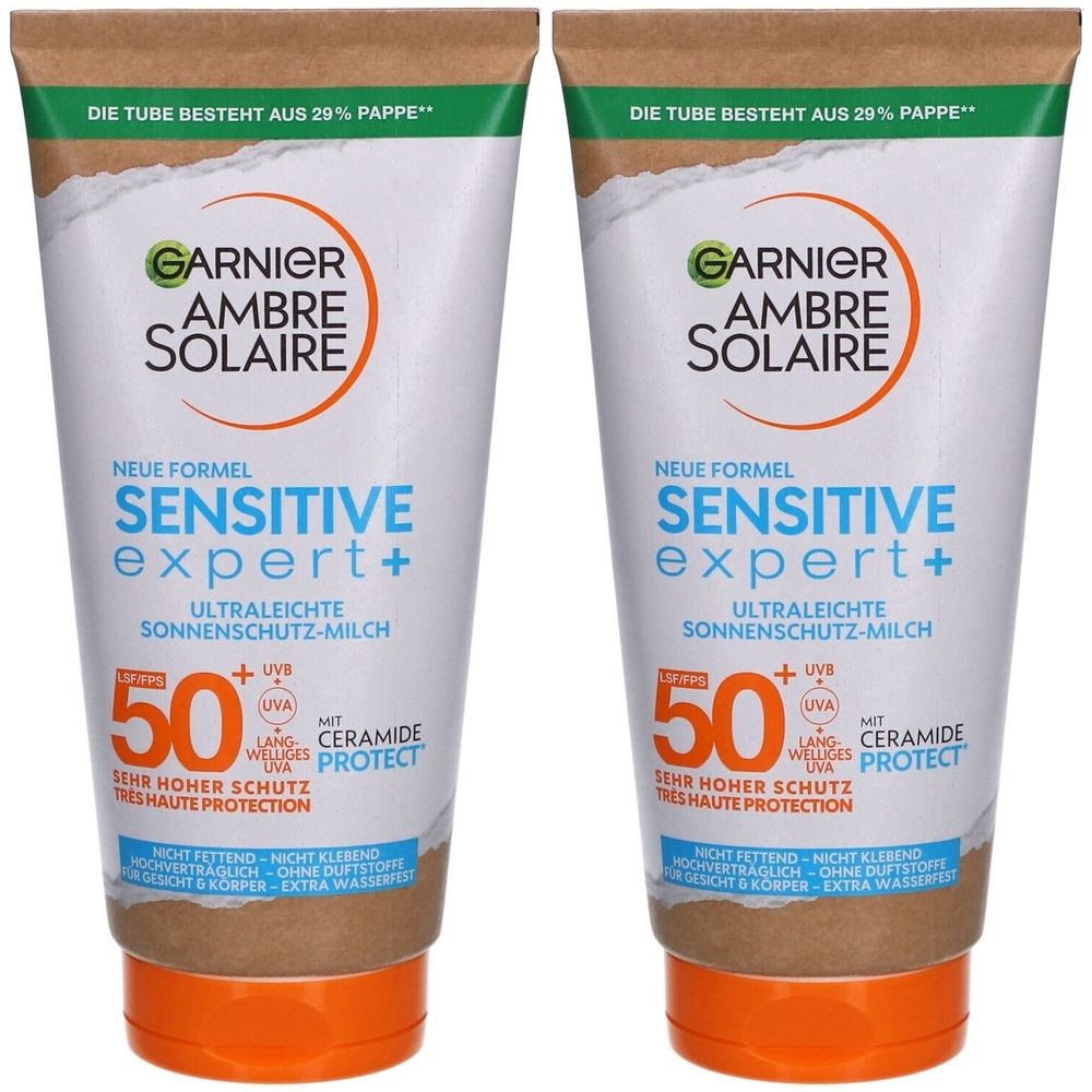 Zwei Tuben Garnier Ambre Solaire Sensitive Expert+ SPF50+ Sonnenmilch. Weiße Tuben mit braunen und orangen Akzenten. Text: 'Sehr hoher Schutz'.