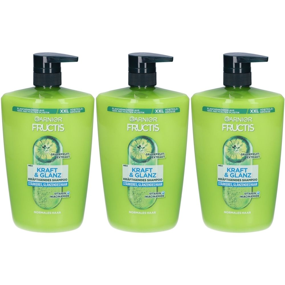 Drei grüne Shampoo-Flaschen mit schwarzem Pumpkopf. Aufschrift: Garnier Fructis, Kraft & Glanz, Kräftigendes Shampoo.
