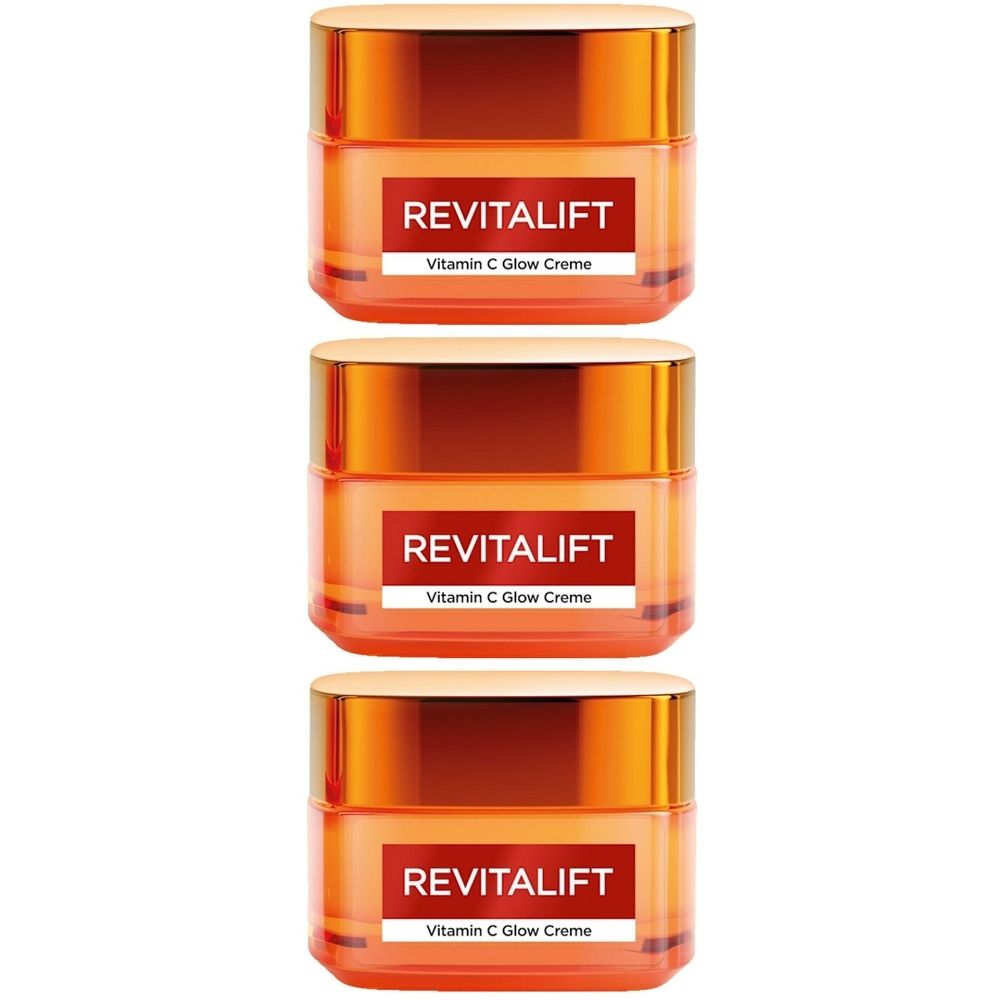 Drei orangefarbene Tiegel mit goldfarbenen Deckeln. Auf jedem Tiegel steht "REVITALIFT Vitamin C Glow Creme".