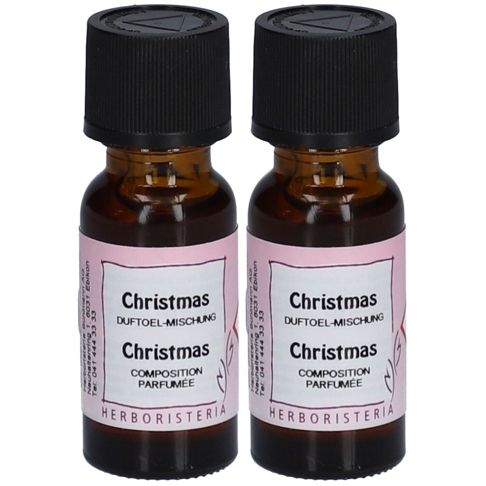 Zwei kleine braune Glasflaschen mit schwarzen Deckeln. Auf den Etiketten steht "Christmas" und "Herboristeria".
