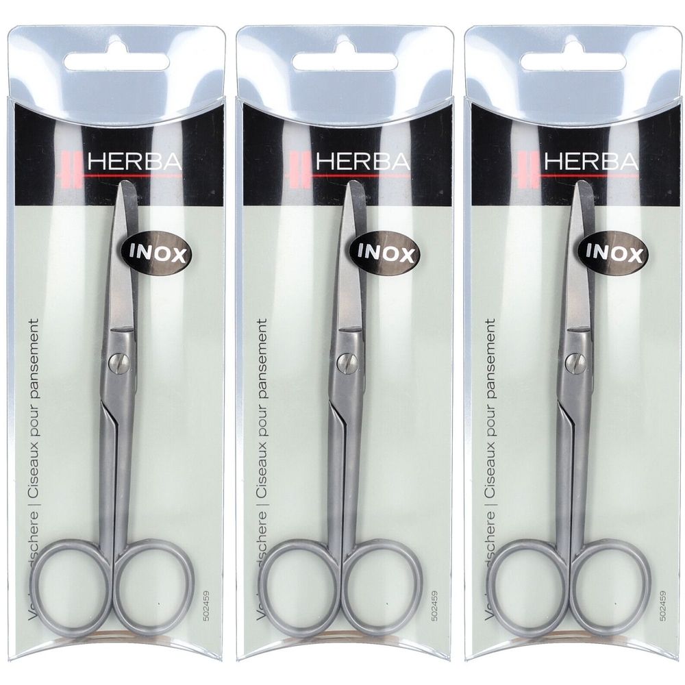 Trois ciseaux à pansement HERBA Inox en blister. Ciseaux métalliques à bouts arrondis. Emballage avec dispositif de suspension.