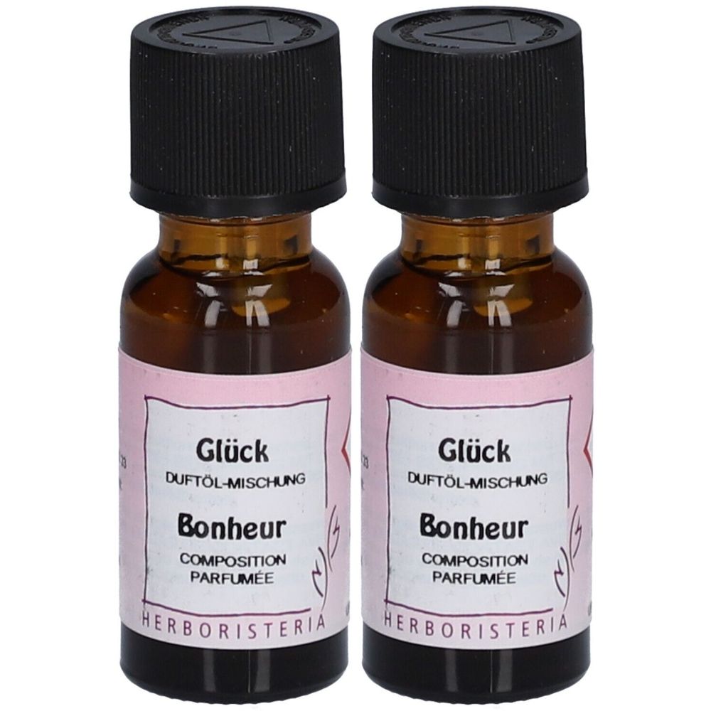 Zwei kleine braune Glasflaschen mit schwarzem Deckel. Auf den Etiketten steht "Glück" und "Bonheur". Der Markenname ist HERBORISTERIA®.