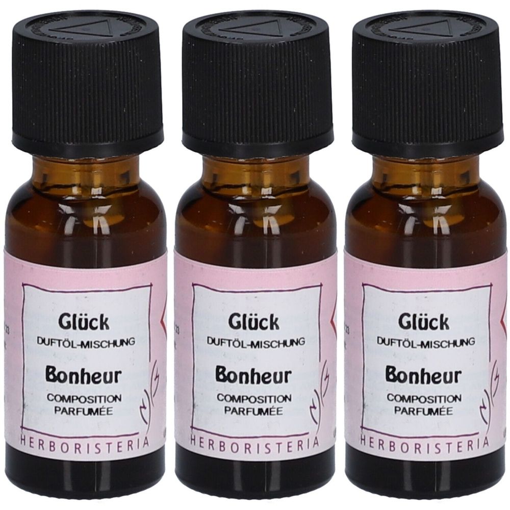 Drei braune Glasflaschen mit schwarzem Deckel. Auf den Etiketten steht "Glück", "Bonheur" und "HERBORISTERIA".