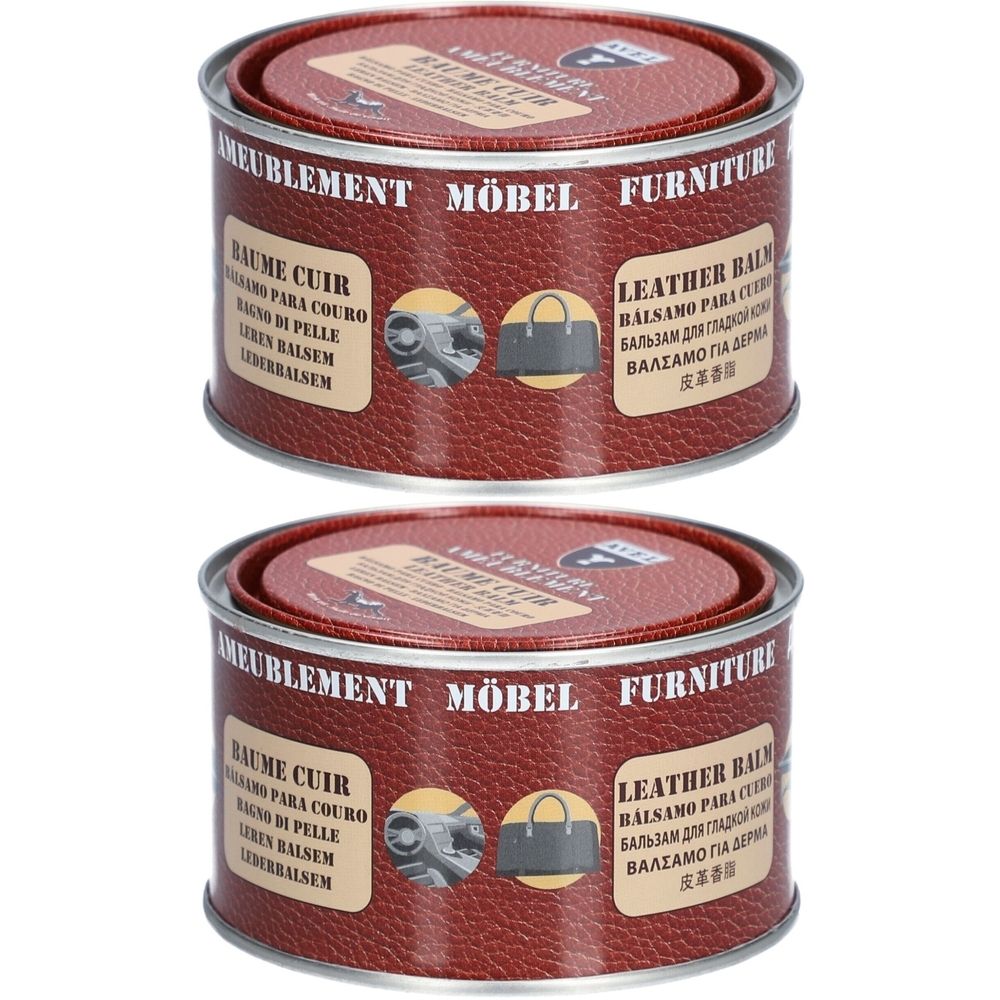 Zwei Dosen Lederbalsam. Rote Deckel und Dosen mit mehrsprachigen Texten. Aufschrift: MÖBEL, FURNITURE, LEATHER BALM.