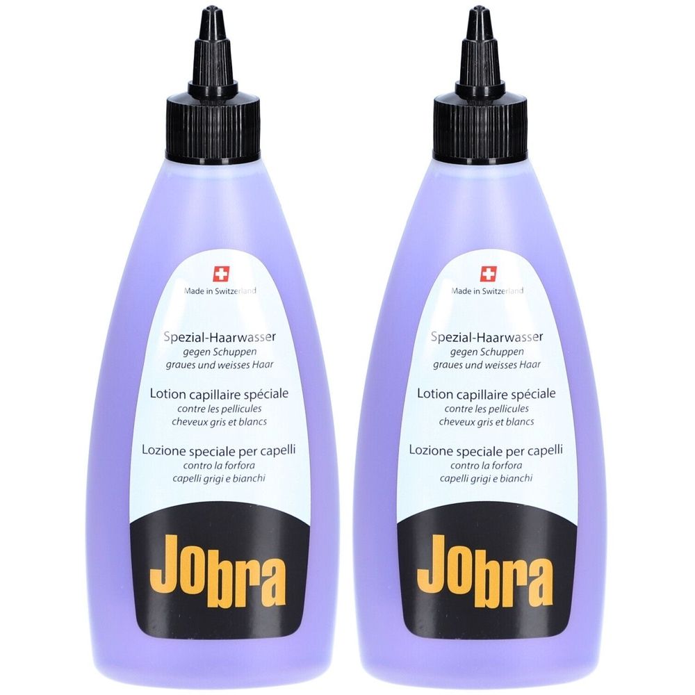 Zwei lilafarbene Flaschen mit schwarzem Verschluss. Aufschrift: Jobra, Spezial-Haarwasser gegen Schuppen. Schweizer Kreuz.