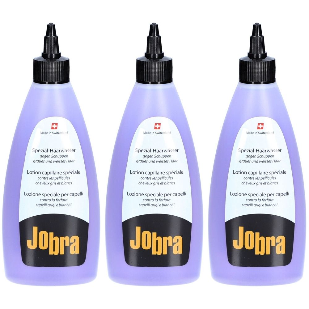 Trois flacons de liquide violet. Bouchon noir. Inscription: Jobra Spezial-Haarwasser contre les pellicules. Croix suisse.