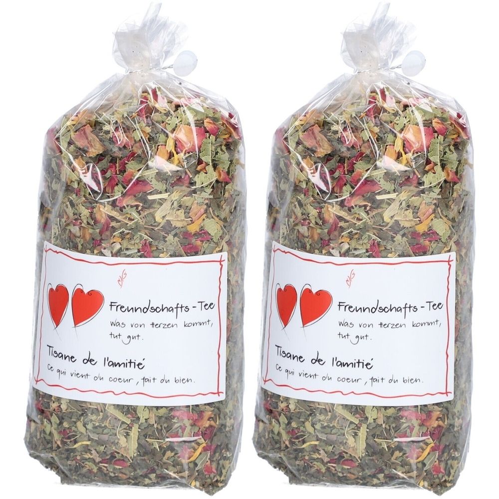 Zwei Beutel Kräutertee in transparenter Verpackung. Aufdruck mit Herz-Symbolen und Text: Freundschafts-Tee, Tisane de l'amitié.