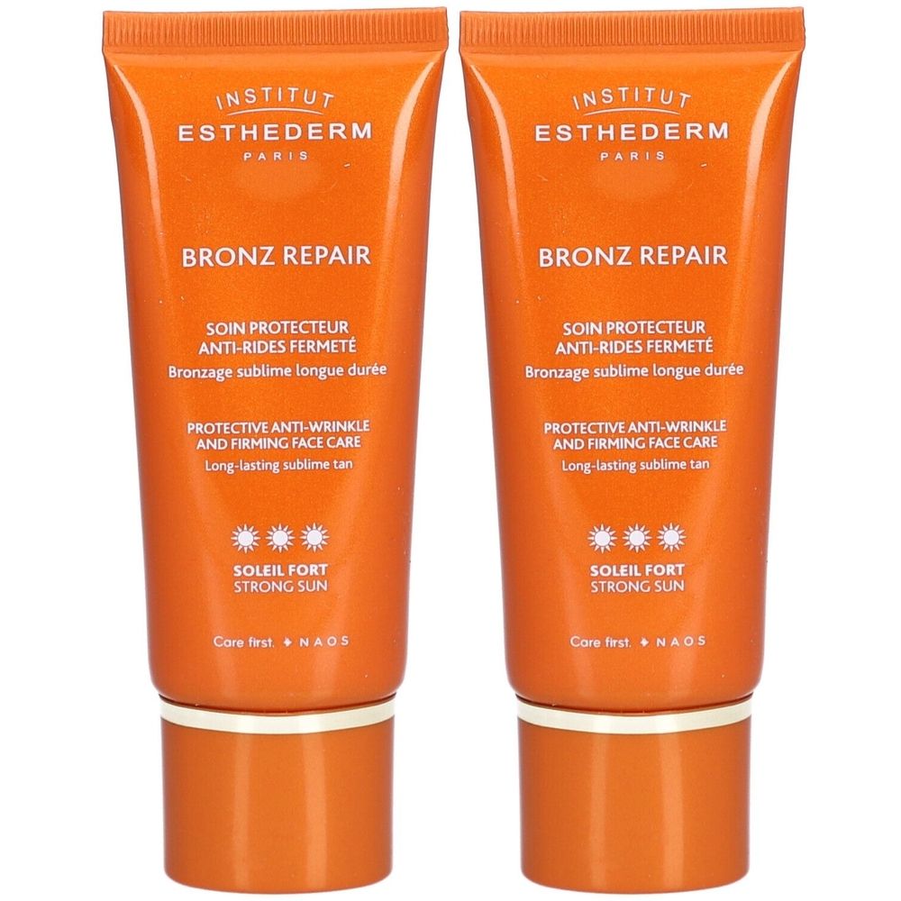 Zwei Tuben Sonnencreme. Orangefarbene Tuben mit weißer Schrift. Aufschrift: Bronz Repair, Soleil Fort, Institut Esthederm.