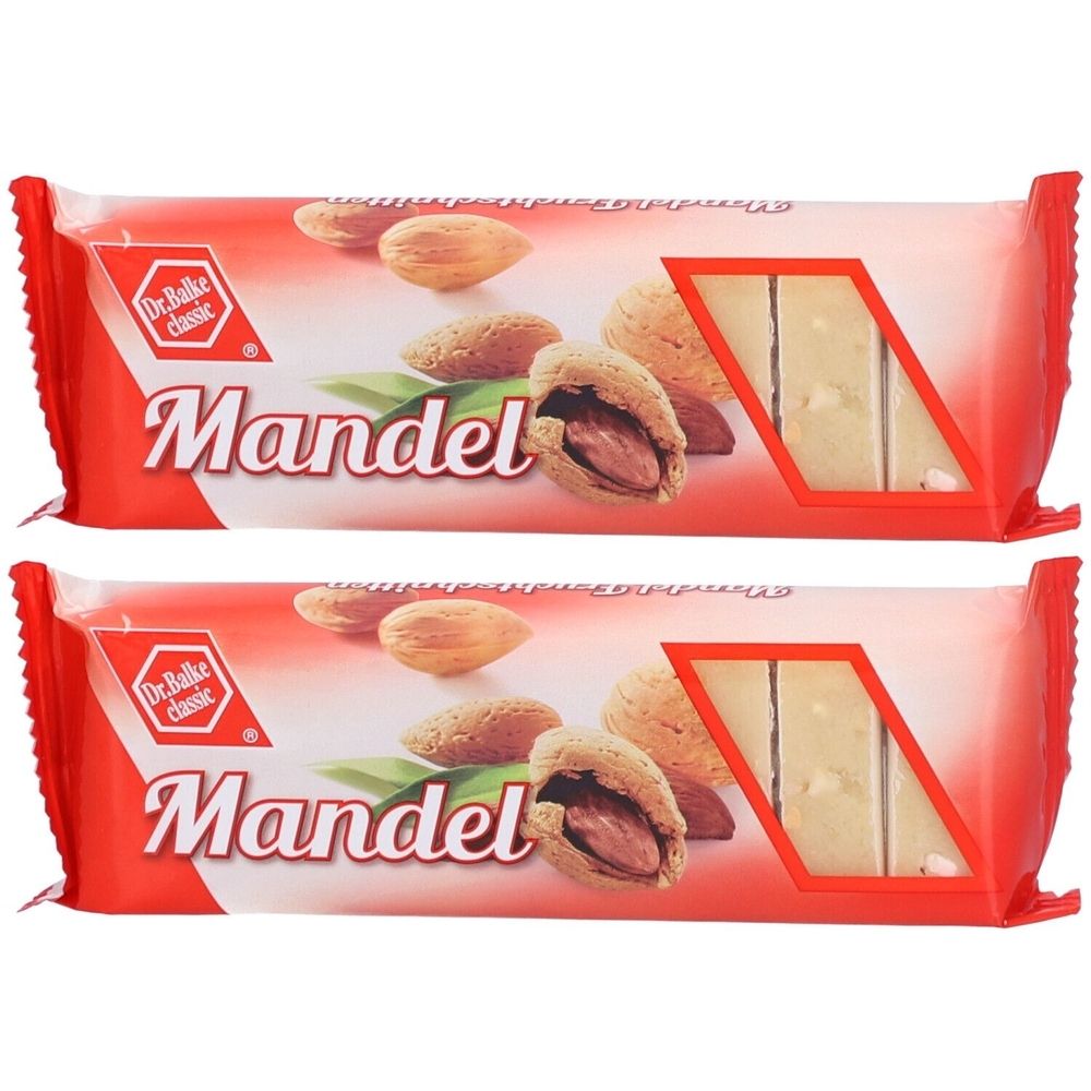 Deux barres de fruits emballées avec des amandes. Emballage rouge avec image d'amandes et inscription "Mandel". Fenêtre avec barre de fruits visible.