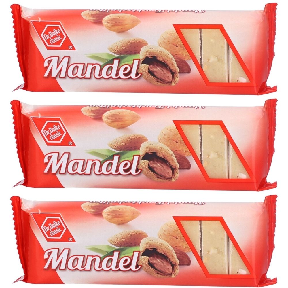 Trois barres emballées. Emballage rouge avec illustration d'amandes et inscription "Mandel". Logo "Dr. Balke classic".