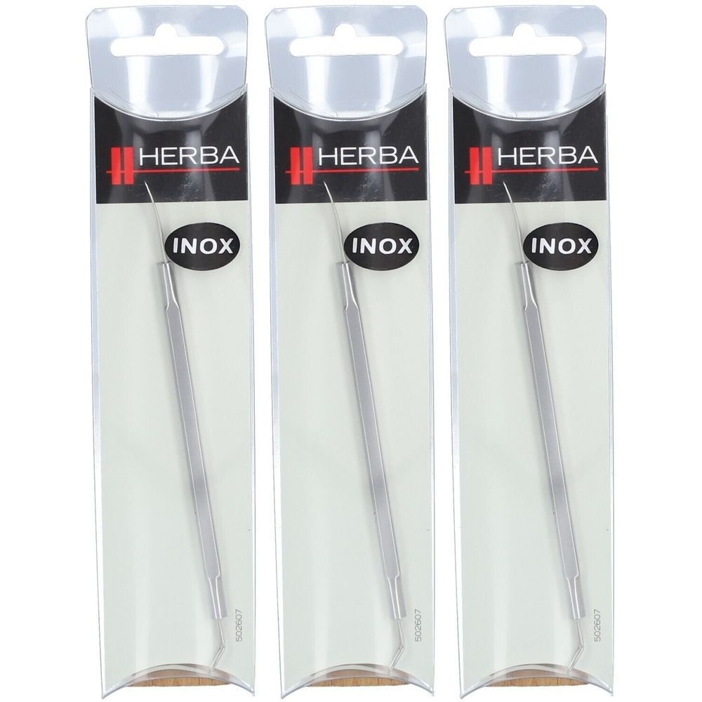 Drei HERBA INOX Mitesserzieher in Verpackung. Edelstahl, länglich, mit Spitze und Schlaufe.