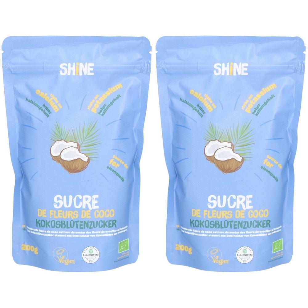 Deux sachets bleus de sucre de fleur de coco. Inscriptions: SHINE, SUCRE, Kokosblütenzucker, 200g, label bio, Vegan.