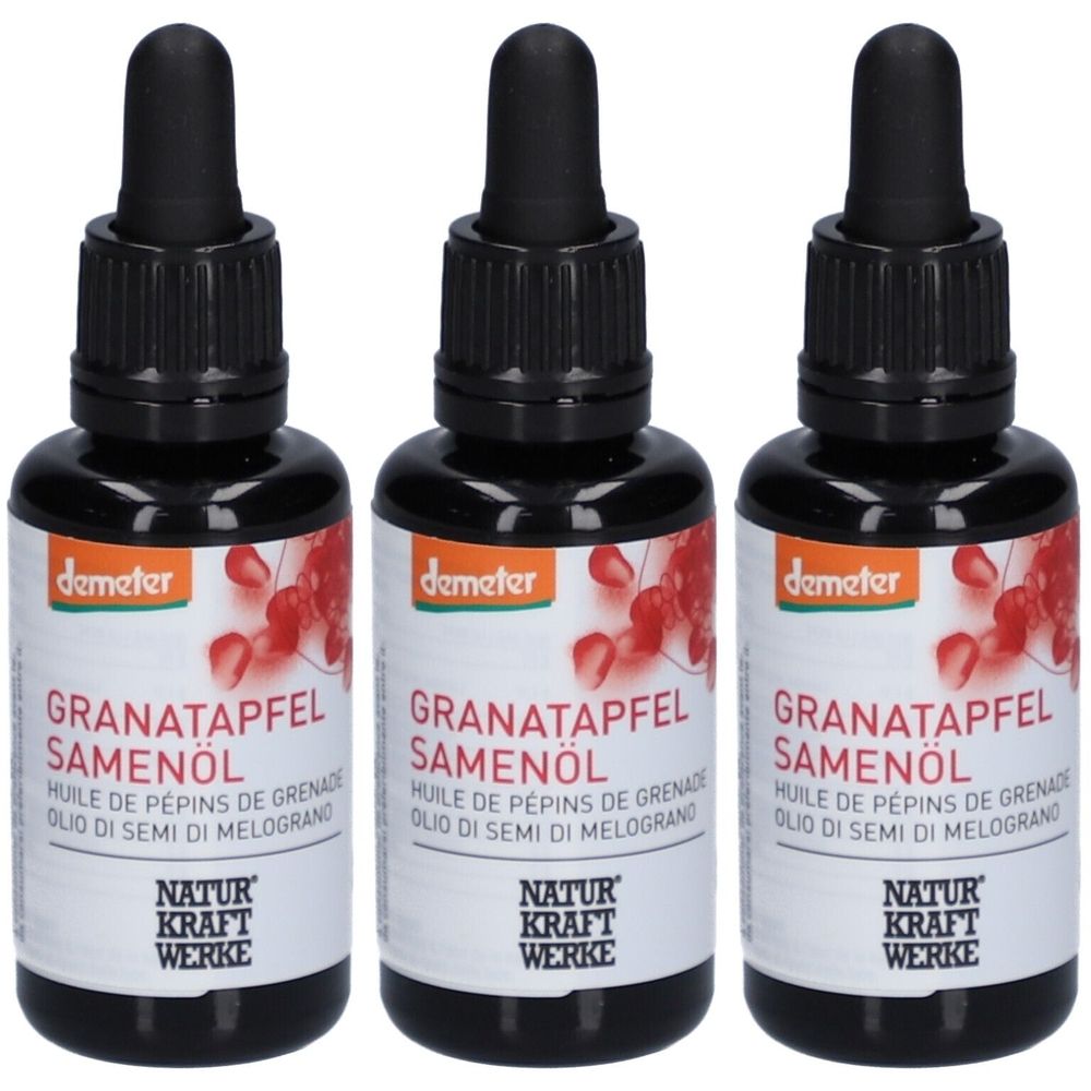 Trois flacons d'huile de graines de grenade avec des bouchons et pipettes noirs. Les étiquettes indiquent "demeter", "Granatapfel Samenöl" et "Natur Kraft Werke".