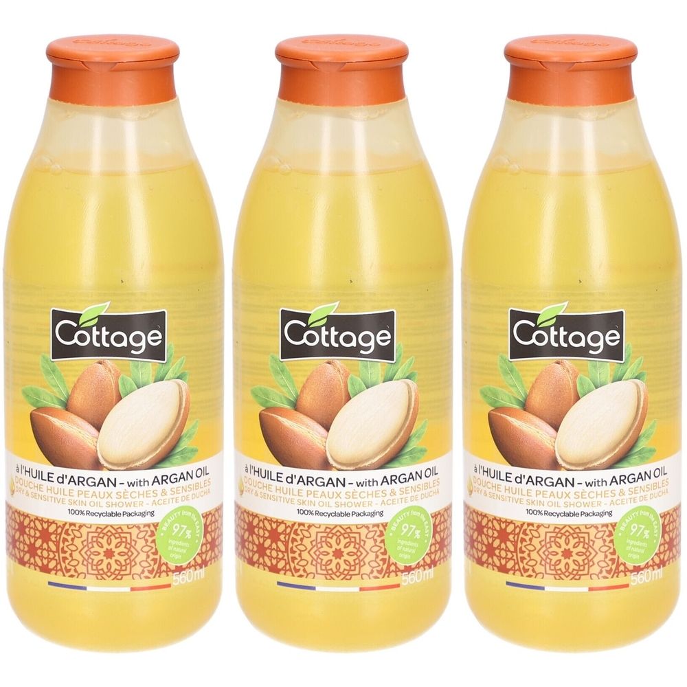 Trois flacons de gel douche à l'huile d'argan. Liquide jaune dans des bouteilles transparentes avec des bouchons orange. Inscription : Cottage, huile d'argan.