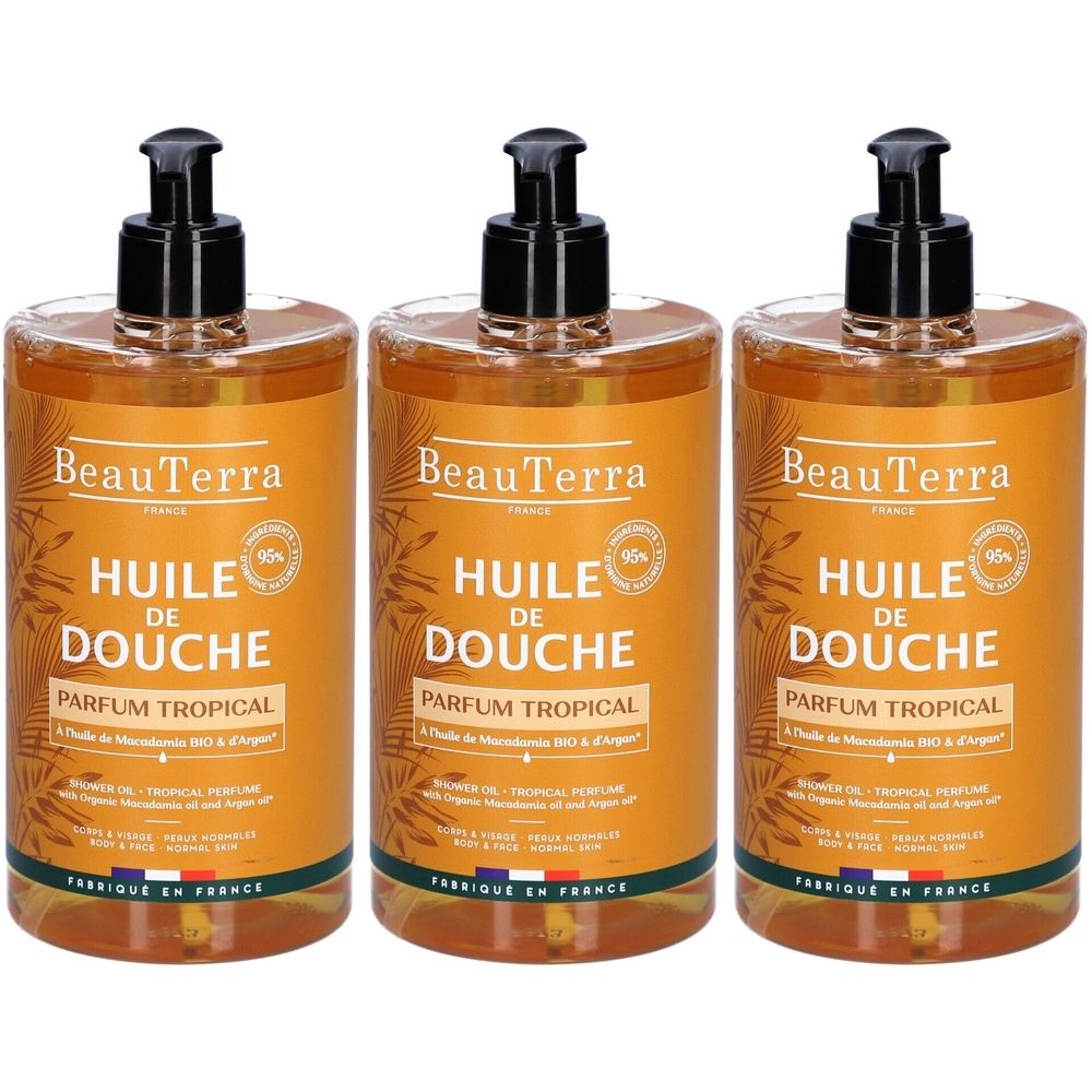Trois flacons d'huile de douche avec pompe noire. Inscription : BeauTerra, Huile de Douche, Parfum Tropical. 95%.