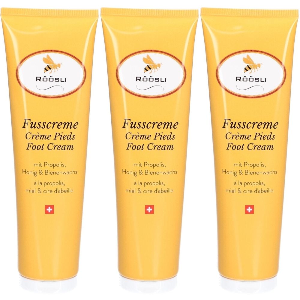 Drei gelbe Tuben Fusscreme. Auf jeder Tube steht "RÖÖSLI", "Fusscreme", "Crème Pieds", "Foot Cream" und weitere Informationen.