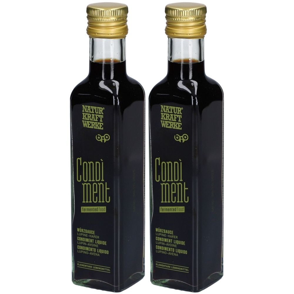 Zwei Flaschen mit goldfarbenen Verschlüssen. Aufschrift: NATURKRAFTWERKE, Condiment, Würzsauce, Lupine-Hafer, Condiment liquide, Condimentos liquidos.
