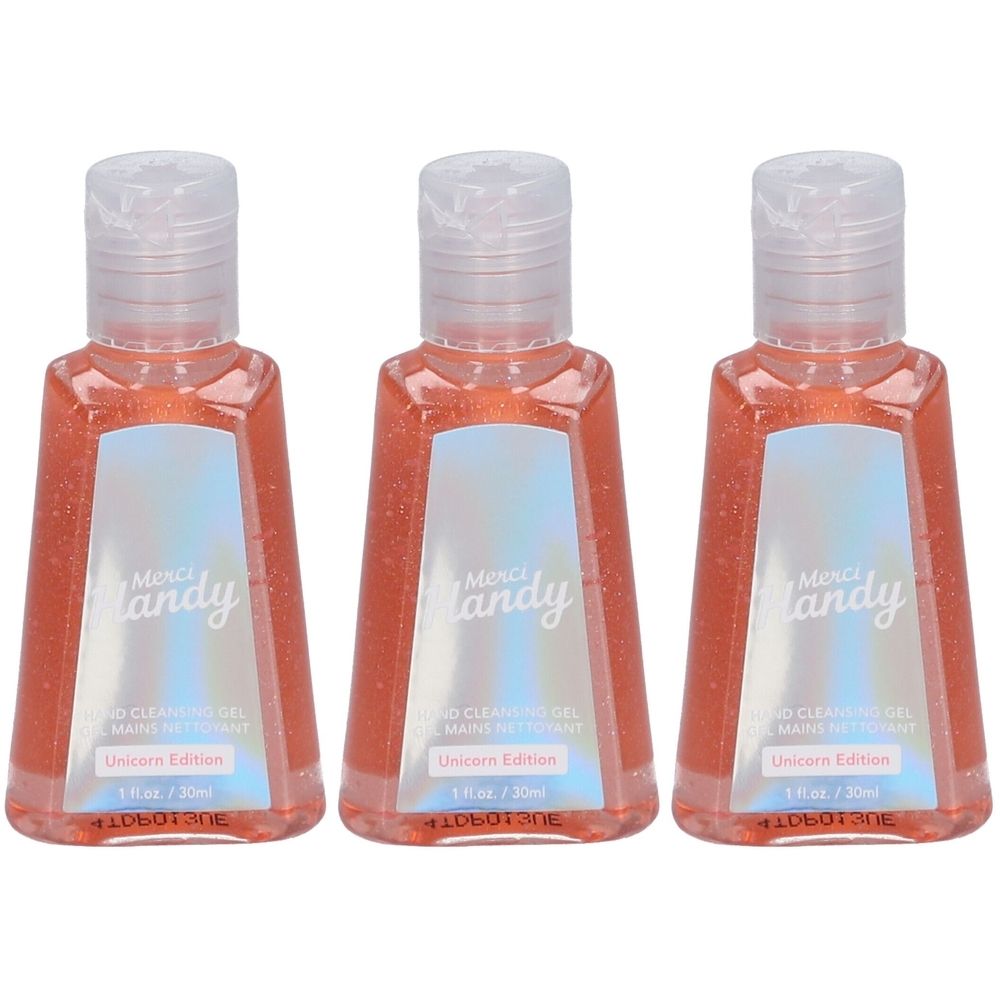 Drei Flaschen Handreinigungsgel. Transparentes Gehäuse mit rosa Inhalt. Aufschrift: Merci Handy, Hand Cleansing Gel, Unicorn Edition.