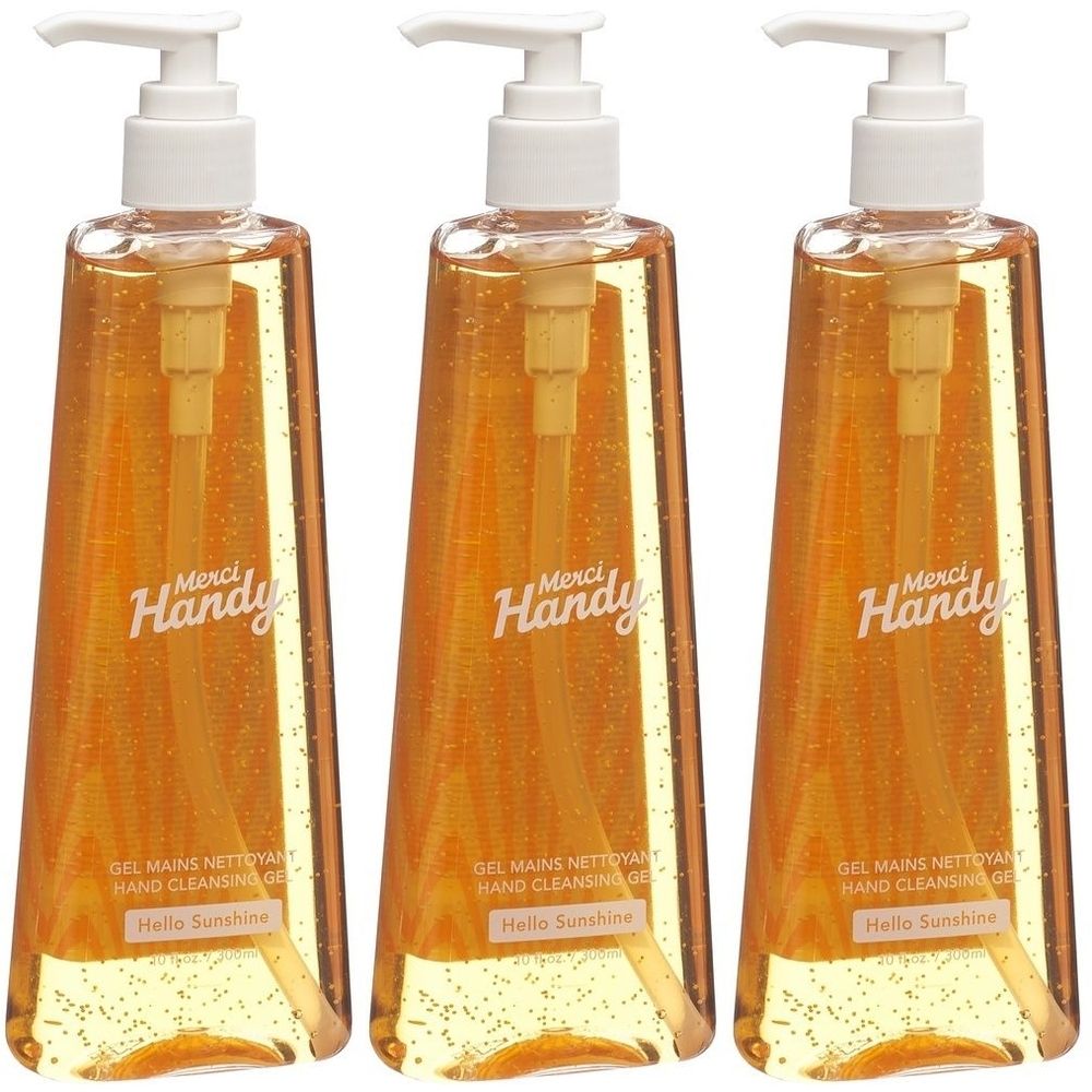 Drei Flaschen Handgel mit Spender. Aufschrift Merci Handy, Gel Mains Nettoyant, Hello Sunshine. Transparente Flüssigkeit, gelb.