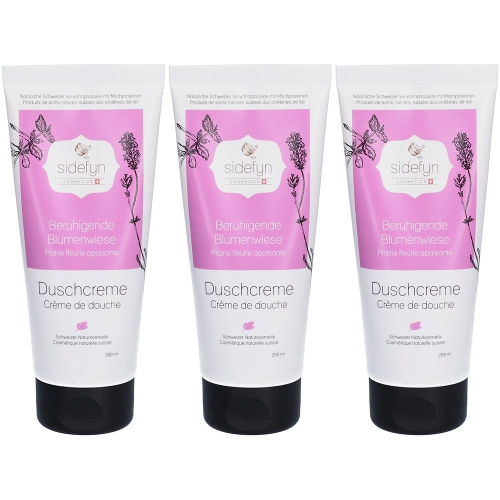 Trois tubes de crème de douche. Tubes blancs avec étiquette rose, motif floral et bouchon noir. Texte : Sidefyn, Beruhigende Blumenwiese, Crème de douche.