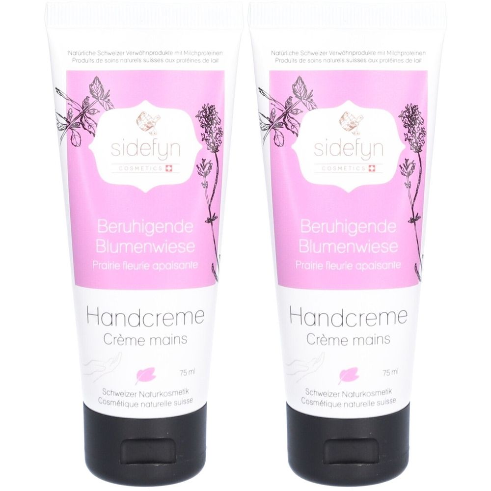 Zwei Tuben Handcreme. Rosa-weißes Design mit floralen Illustrationen und Text: "Beruhigende Blumenwiese", "Handcreme", "sidefyn". Schwarze Kappen.