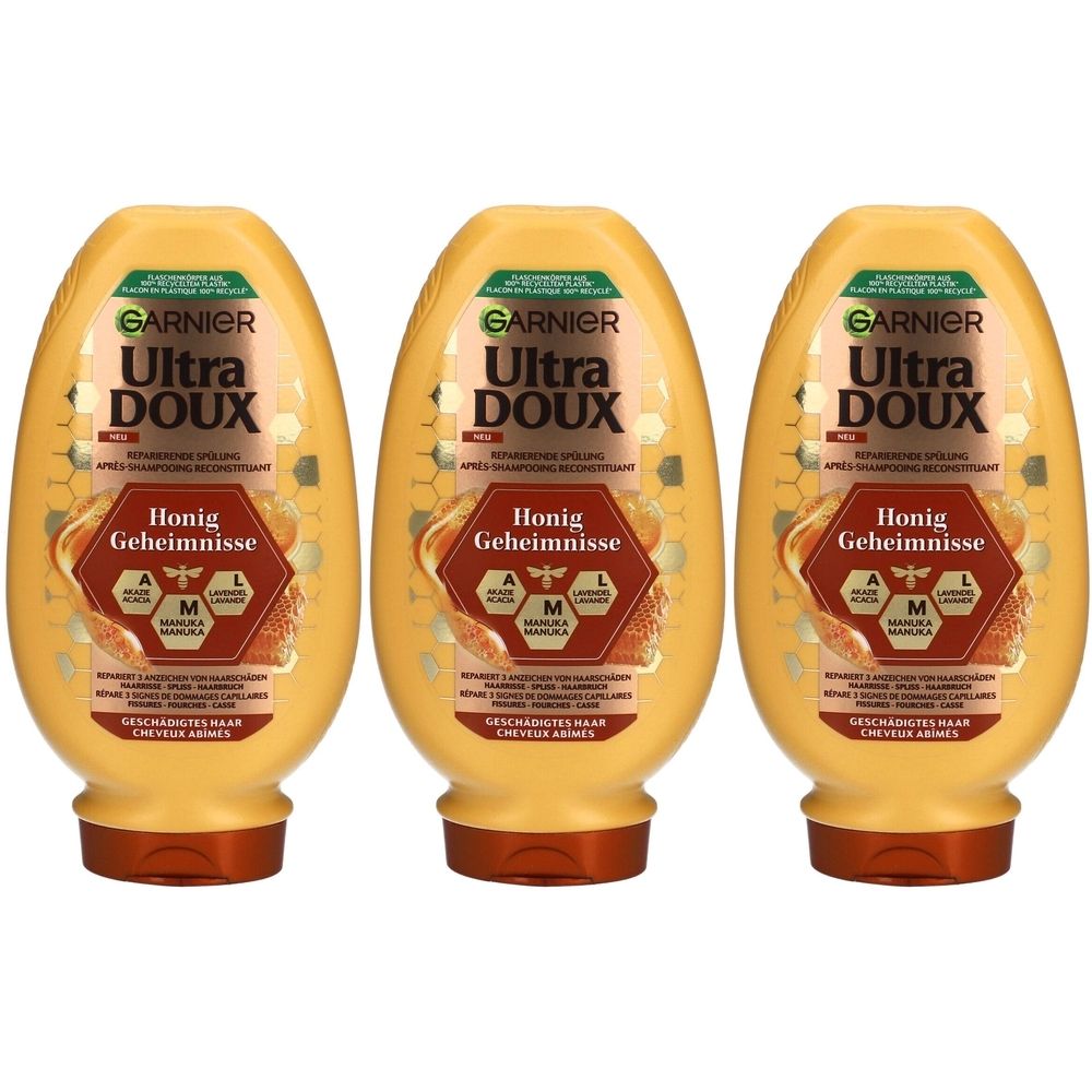 Drei gelbe Flaschen mit braunen Deckeln. Auf jeder Flasche steht "GARNIER Ultra DOUX Honig Geheimnisse".