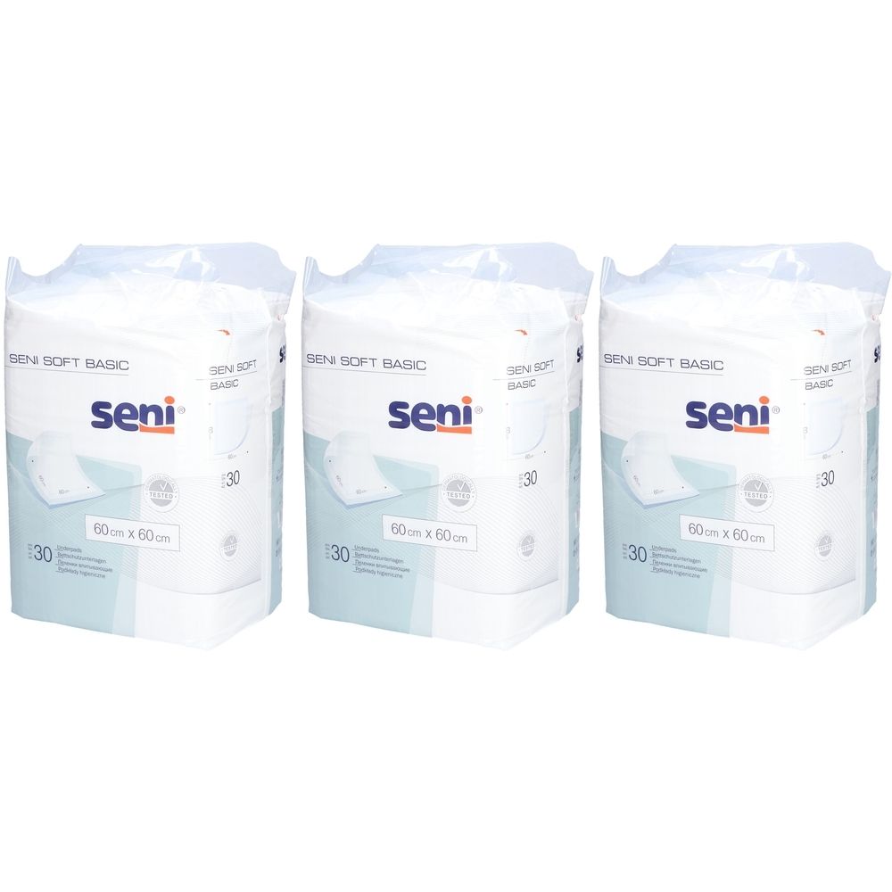 Trois paquets de protections Seni Soft Basic. Chaque paquet contient 30 unités de 60x60cm. Le logo Seni est visible.