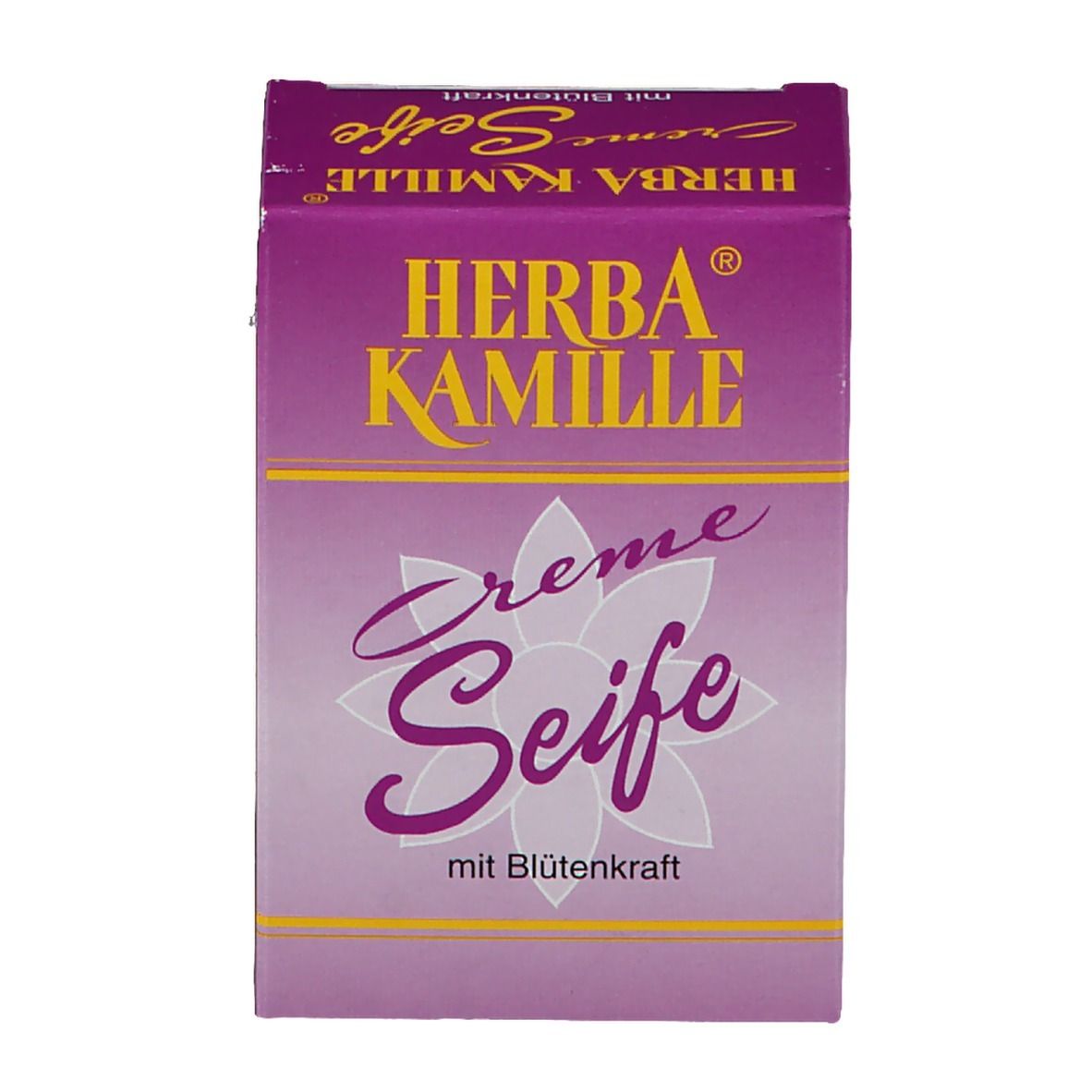 Savon Herba Kamille Crème dans un emballage violet. Inscription jaune. Motif floral. Vue de dessus.