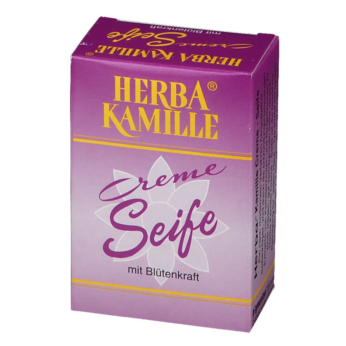 Savon Herba Kamille Crème dans un emballage violet. Inscription jaune. Motif floral. Vue latérale.