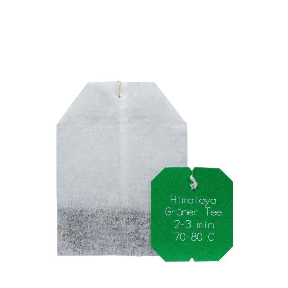 Sachet de thé avec étiquette verte. Impression avec nom du produit, instructions de préparation et logo.