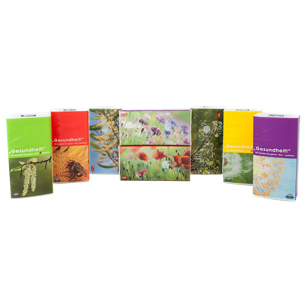 Mehrere Packungen mit Naturmotiven, darunter Blumen und Insekten. "Gesundheit!" ist auf einigen Packungen sichtbar.
